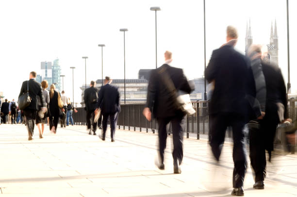 istock City workers commuters walking with movement blur, London UK 157310419