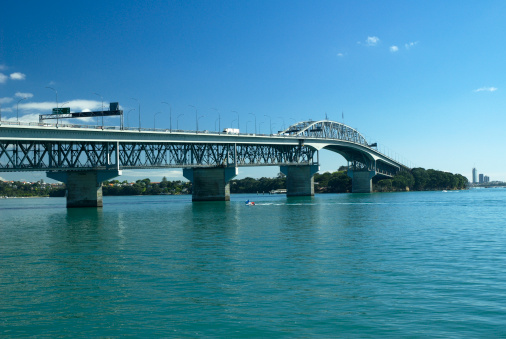 Auckland Harbour Bridge on sunny morning, takapuna high rises in the background