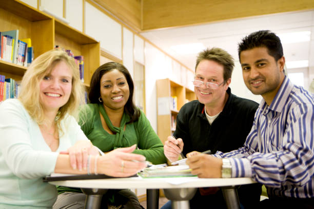 istock adult education: smiling diverse group of mature students working together 157310680