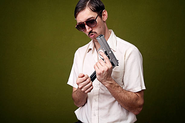 A sleek black handgun is elegantly positioned alongside soft, flowing pink ribbons, creating a striking visual contrast