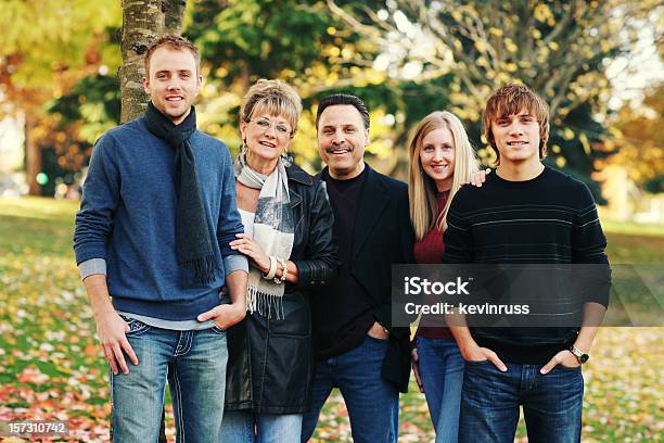 Happy Family In Jeans Together At A Park Stock Photo - Download Image Now - Adult, Autumn, Beautiful People