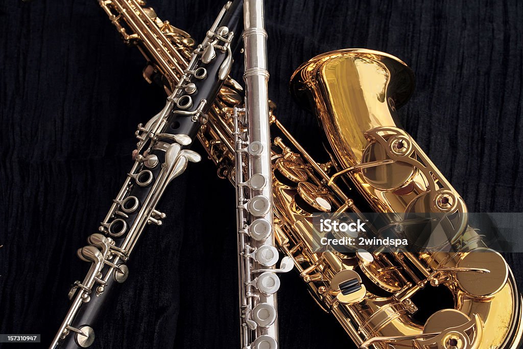 Clarinet, Flute and Alto Sax Collage A closeup collage of clarinet, flute and alto saxophone on textured black velvet.  Clarinet Stock Photo
