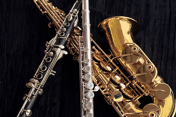 Clarinet, Flute and Alto Sax Collage A closeup collage of clarinet, flute and alto saxophone on textured black velvet.  big band jazz stock pictures, royalty-free photos & images