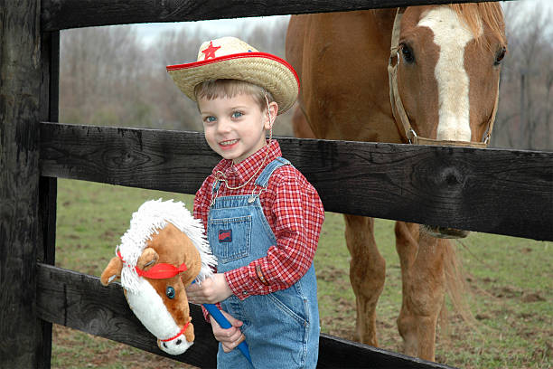 Happy kid riding horse in nature, horseback lesson outdoors