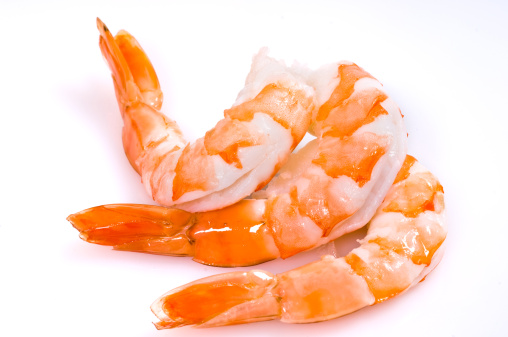 Shrimps salad with ginger and chili in mango sauce on wooden background