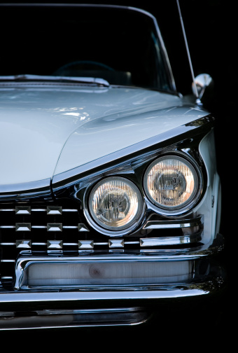 Close-up of headlights of modern car model. Action. Daytime running lights of new car. Beautiful front lights of new car in cloudy weather.