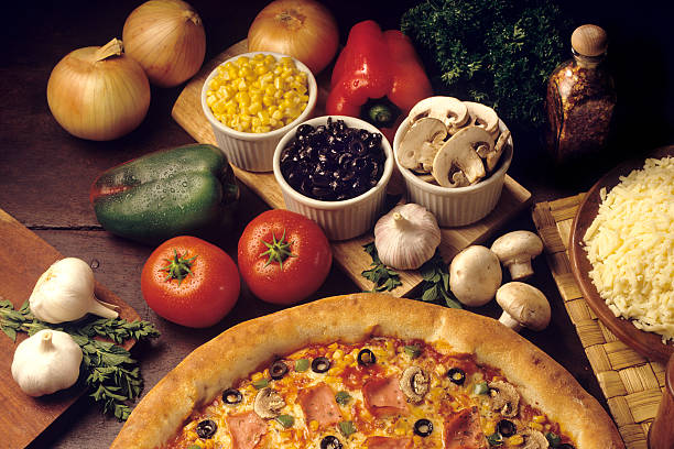 Freshly made pizza out of the oven features a generous layer of melted cheese, vibrant vegetables, and savory toppings, ideal for sharing with friends during a cozy evening.