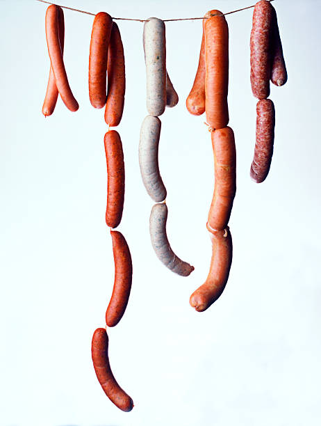 Sausages hanging on a white background stock photo