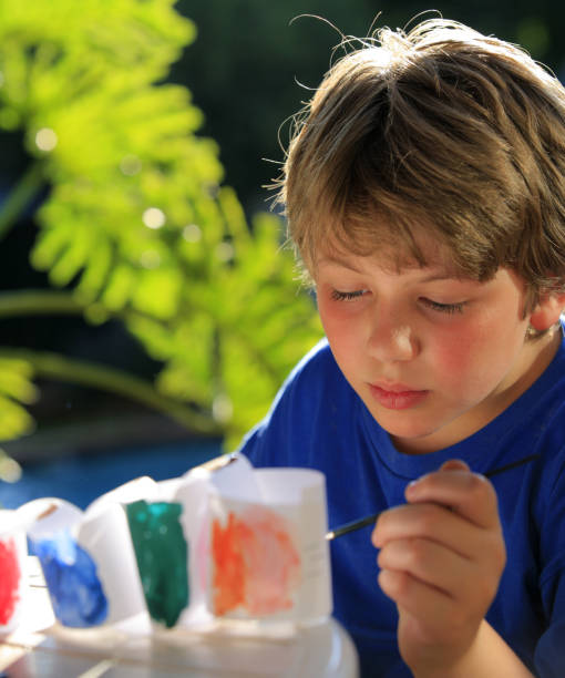 istock Schoolboy doing arts and crafts 157311716