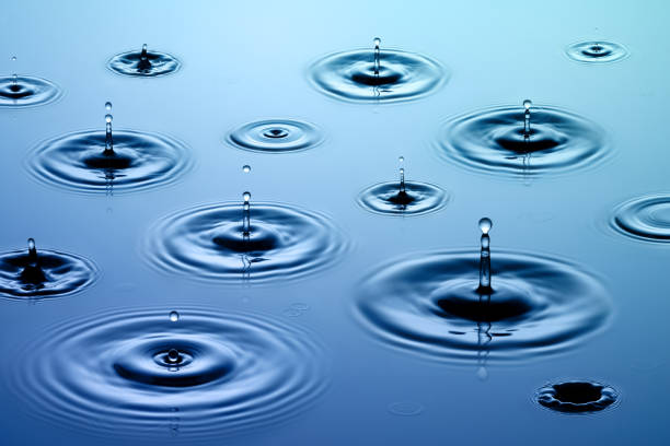 istock Drops of rain on water surface creating ripples 157311853