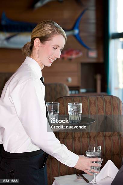 Beautiful Blond Restaurant Waitress Serving Water At Table Copy Space Stock Photo - Download Image Now
