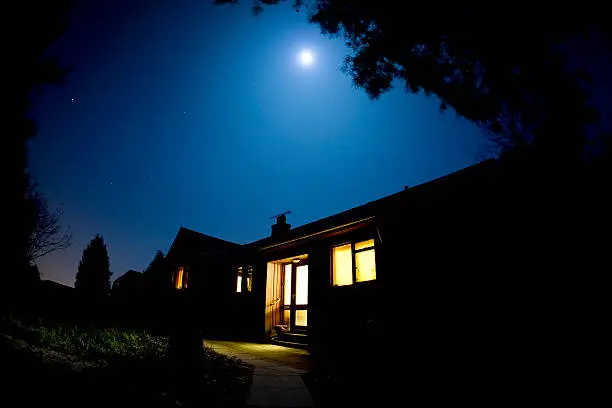 A wooden house lit by the moon.  