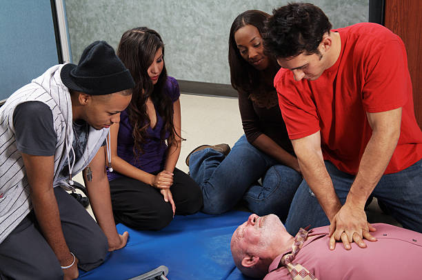 CPR chest compressions being done on victim stock photo