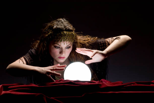 istock fortune teller looking at crystal ball 157312036