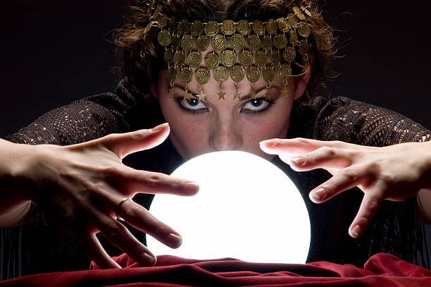 istock fortune teller with glowing crystal ball 157312038