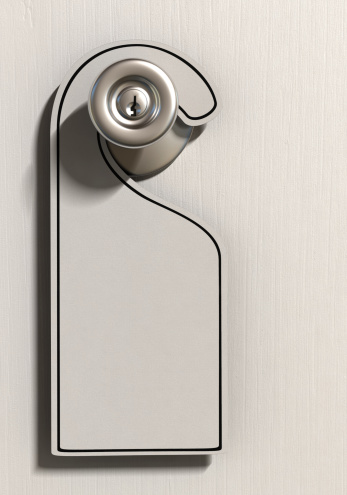 A blank tag hanging on a door handle on a white painted door. Very high resolution 3D render.