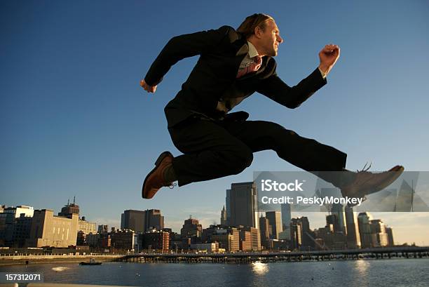 Businessman Jumping Over City Skyscraper Skyline Stock Photo - Download Image Now - Businessman, Activity, Adult