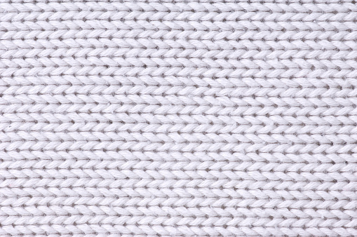 Carpet doormat or white beach towel texture background in light grey color made of wool or synthetic fibers, polypropylene, nylon or polyester material