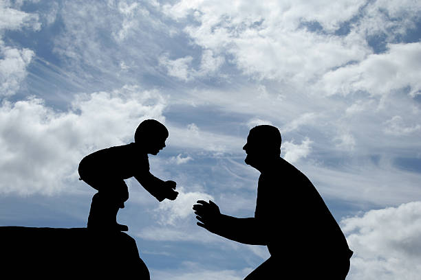istock Silhouettes of a father and son playing 157312154
