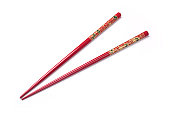 Two red chopsticks on a white background