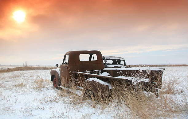 White old car covered with snow after the winter blizzard