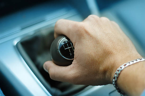 Hand downshifting car five speed manual transmission stock photo