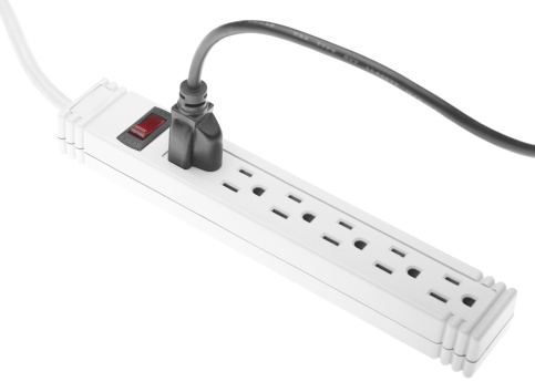 A surge protector/power strip with a single cord plugged in.