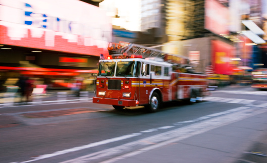 Red Fire Engine racing through Time Square NYC.