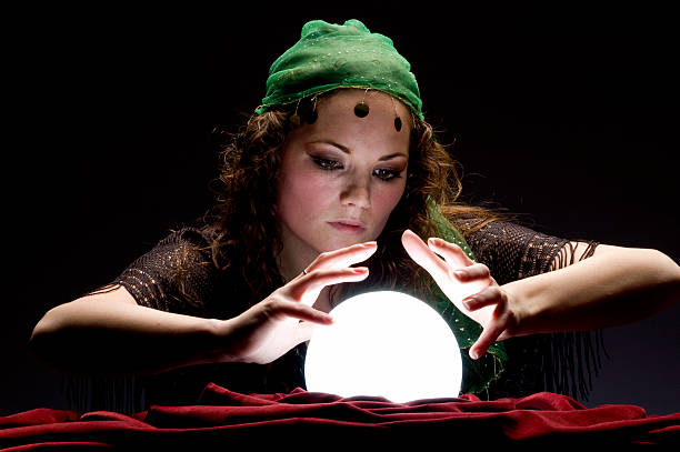 istock fortune teller focussed on crystal ball 157312721