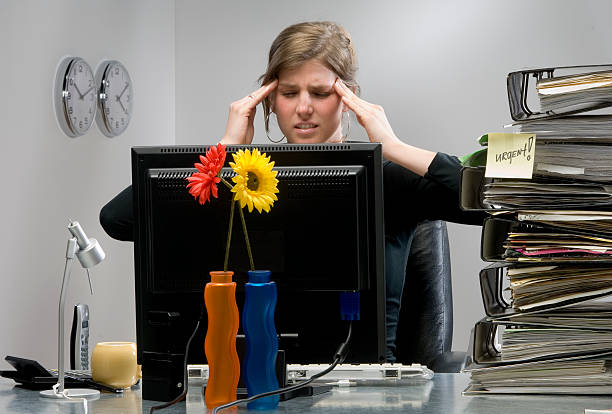 istock businesswoman with headache in office at work 157312778