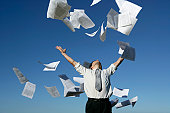 Businessman throwing papers