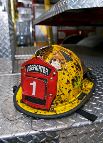 This helmet has seen some action. Photographed on the deck of a fire engine. Need photos of firefighters or related gear? Please see these...  