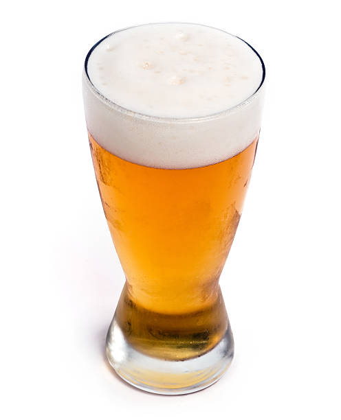 Glass of cold draft pilsen beer Glass of cold draft pilsen beer from above on white background glass of beer stock pictures, royalty-free photos & images