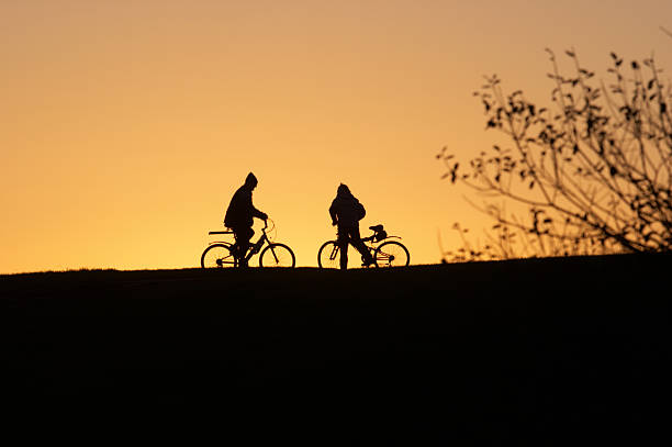 istock Dusk cyclist in silhouette couple together 157313386