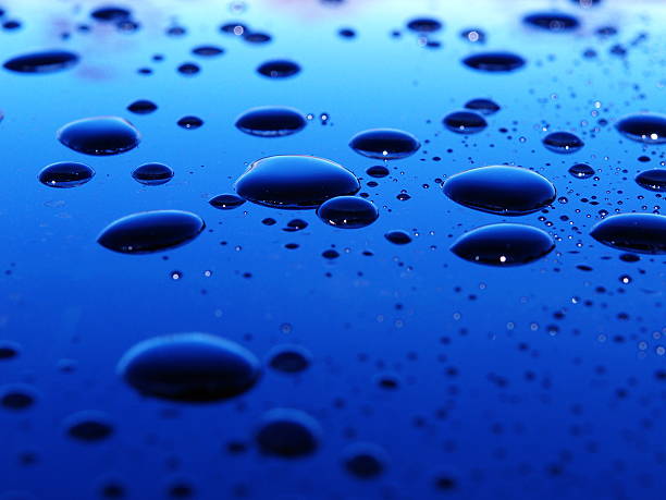 Several dark bubbles on a blue background stock photo