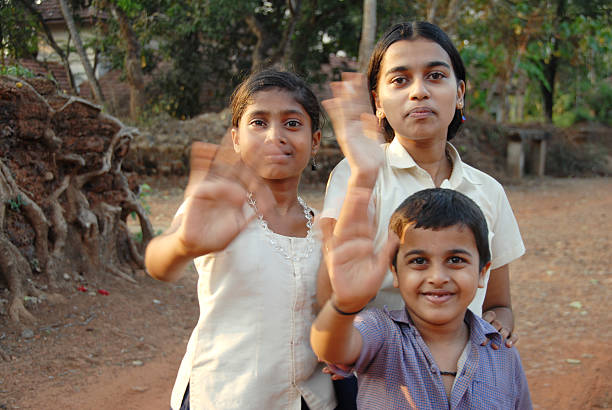 3 indian kids waving with their hands, hands with motion blur