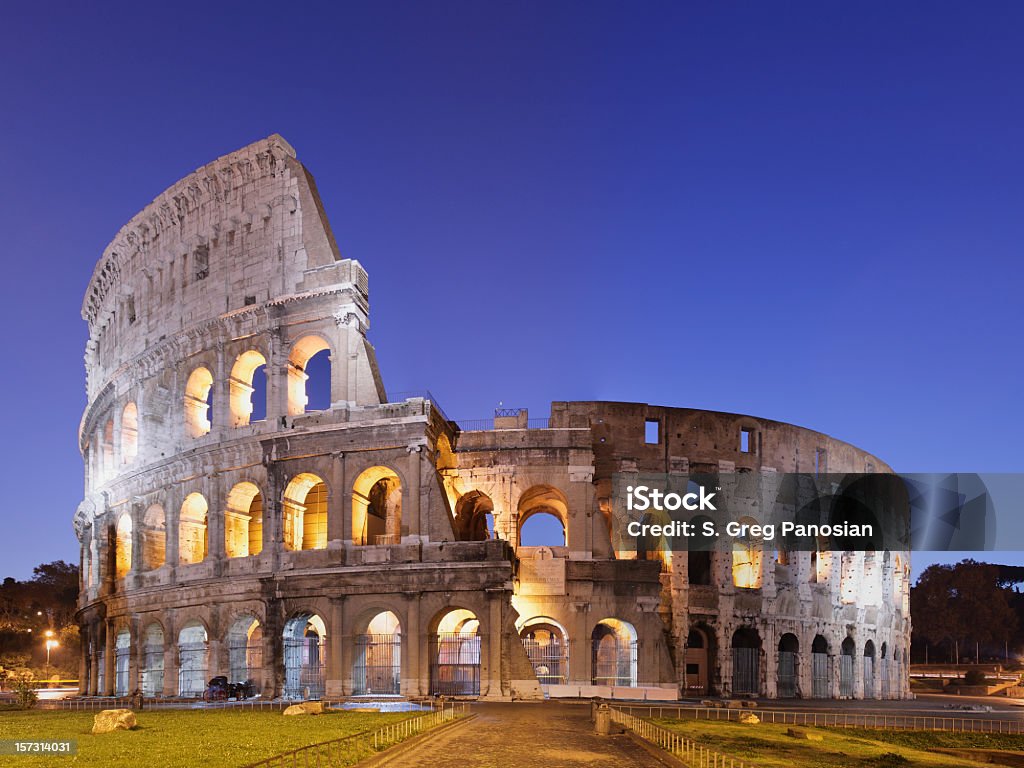 Photo of the Coliseum in Rome against blue sky The Coliseum at night (Rome, Italy). Coliseum - Rome Stock Photo