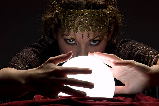 istock fortune teller with glowing crystal ball 157314209