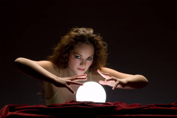 istock fortune teller with glowing crystal ball 157314210