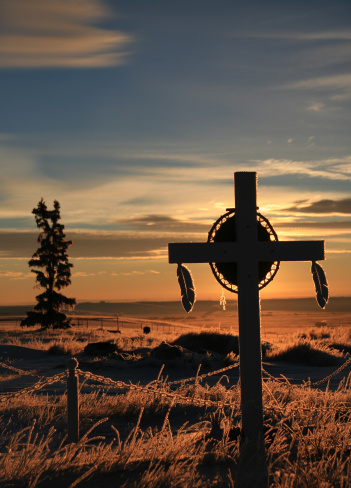 A graveyard on a First Nations reserveration. Alberta, Canada. This graveyard is a holy sacred place on an Indian Reservation near Gleichen, Alberta on the Siksika Nation. Many indian reservations and tribes dot the plains. The Blackfoot, Peigan, Blackfeet, Ojibwa, Blood, and Siksika are just a few of these tribes, nations, and indigenous groups. 