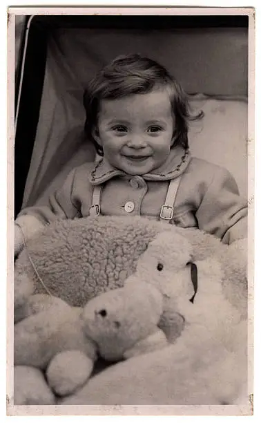 Photo of Nineteen forties baby in pram, with teddy bear