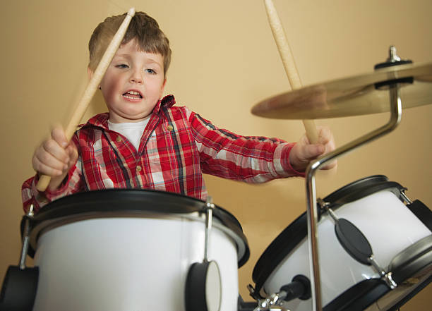 istock A little boy playing on a starter set of drums 157314598