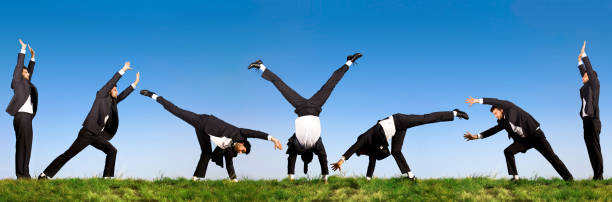 istock acrobatic business man in black 157314772
