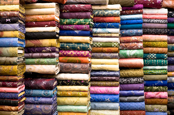 Patterned Textile Fabrics on Display A large number of colourful materials on display. fabric shop stock pictures, royalty-free photos & images
