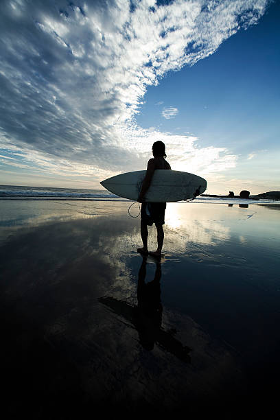 istock Joy being represented by a man with surfboard in sunset 157314964