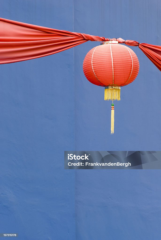 Red Chinese paper lantern Chinese paper lantern celebrating Chinese New Year, against a blue wall. Asia Stock Photo