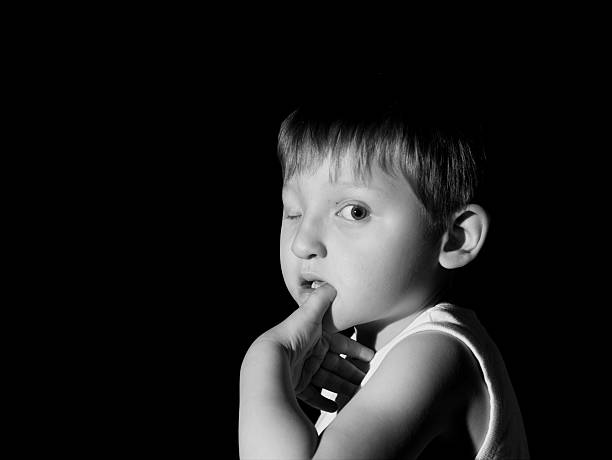 istock Lost - Young boy in white vest b&w 157315195