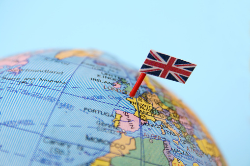 United Kingdom flag pointing London in cheap plastic globe. Shallow depth of field