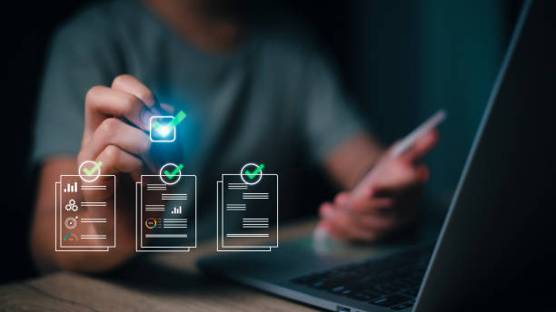 istock Prepare check and approve concepts. Document management, paperless. Women tick mark documents for online approval paperless quality assurance and ERP management. 1573153836