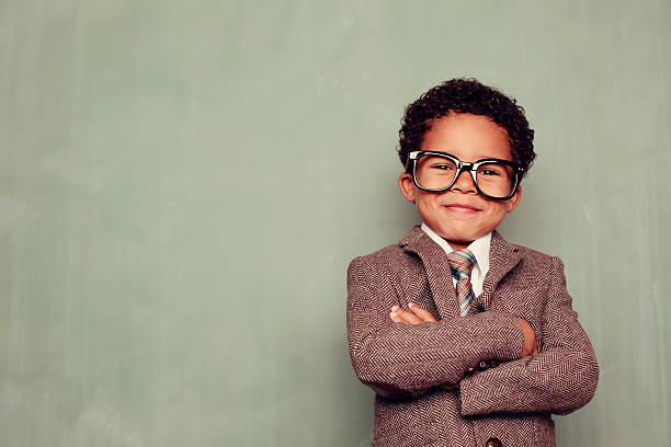Happy Teacher A young boy and knowledge whiz is ready to teach the class. Just add smart copy for the perfect concept. black nerd stock pictures, royalty-free photos & images
